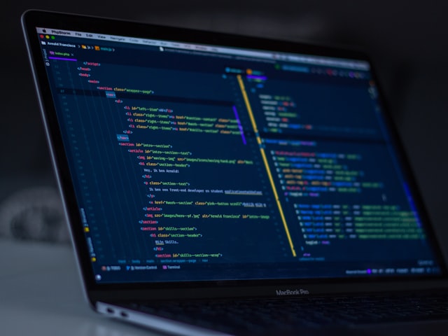 Developer writing custom software on a laptop